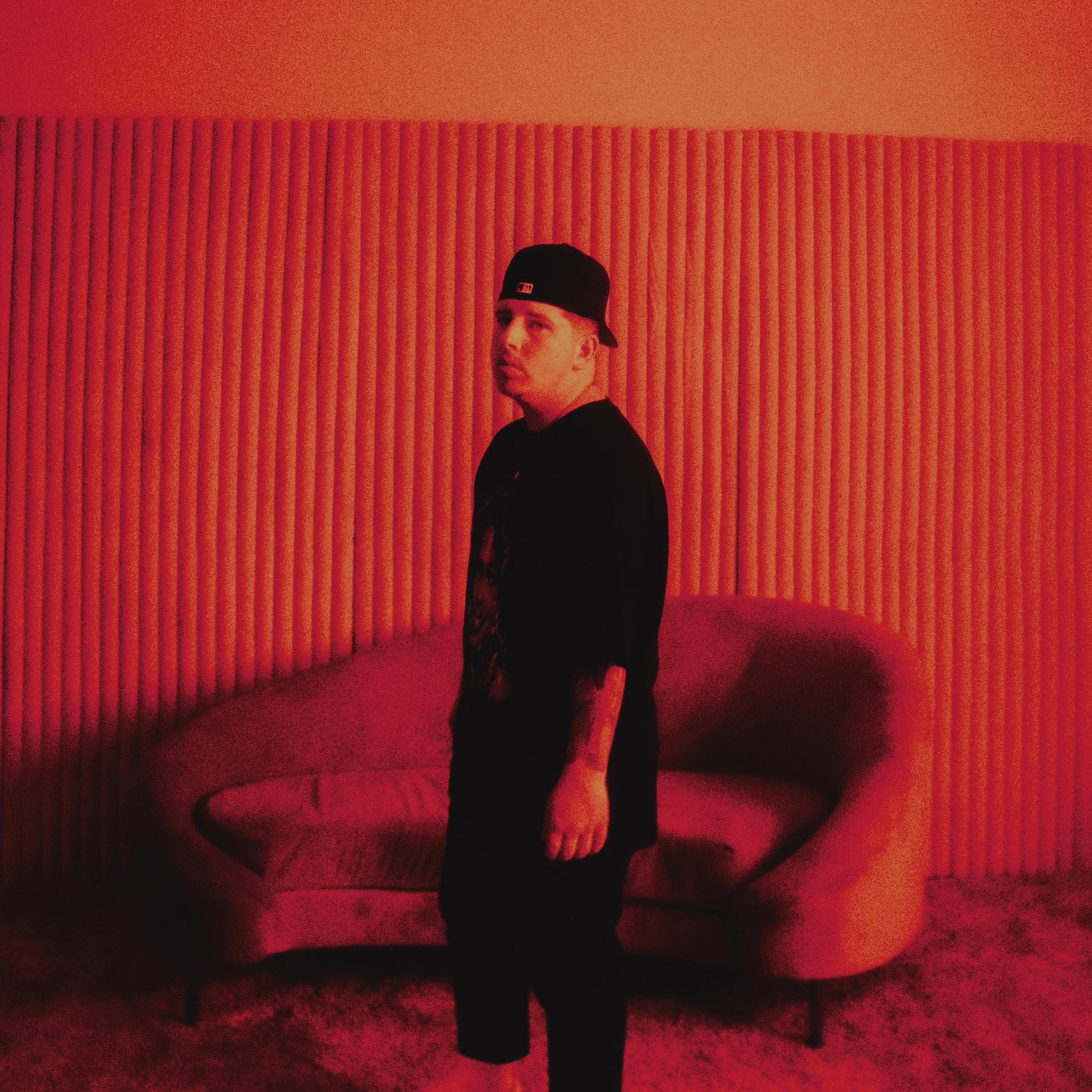 Photo of Dylan Reese standing in a room with a red tint